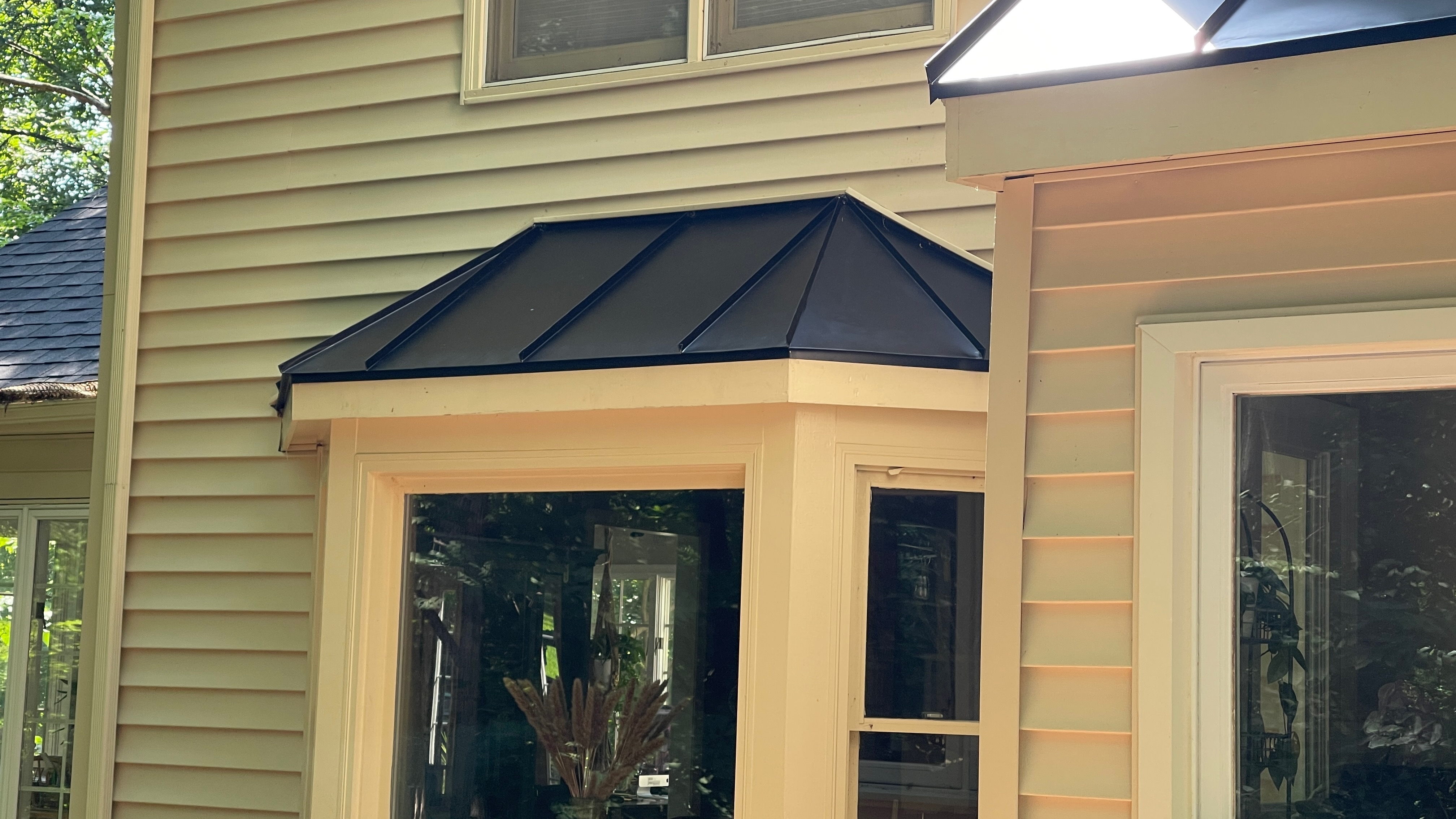 Black standing seam metal bay-window roof in Northern Virginia