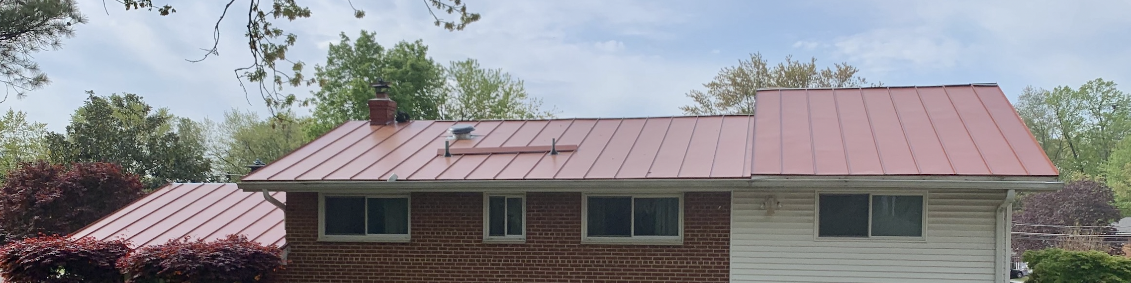 Red standing seam metal roof on a home in Northern Virginia